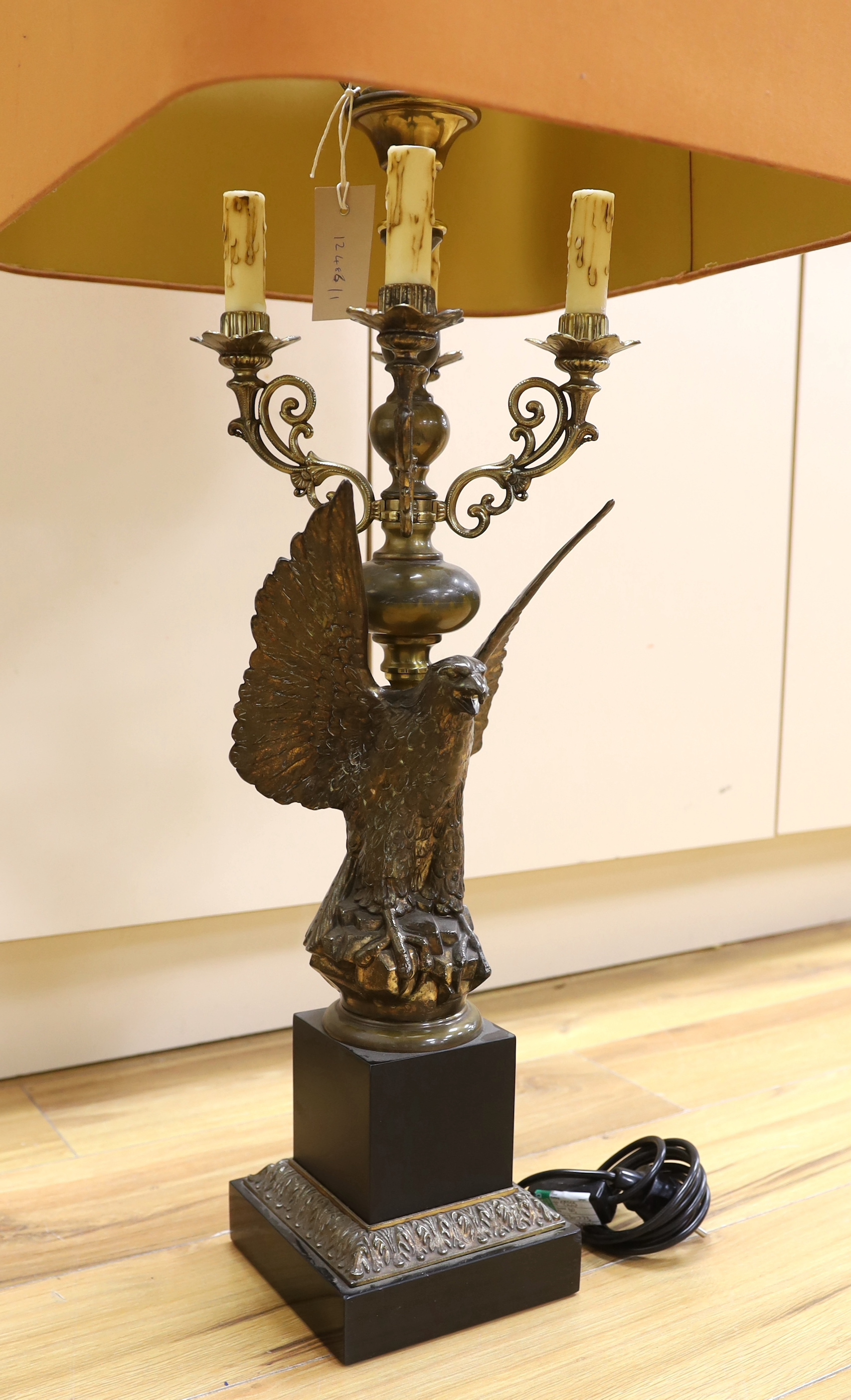 A Loevsky and Loevsky gilt metal ‘eagle’ table lamp with shade, 98cm total